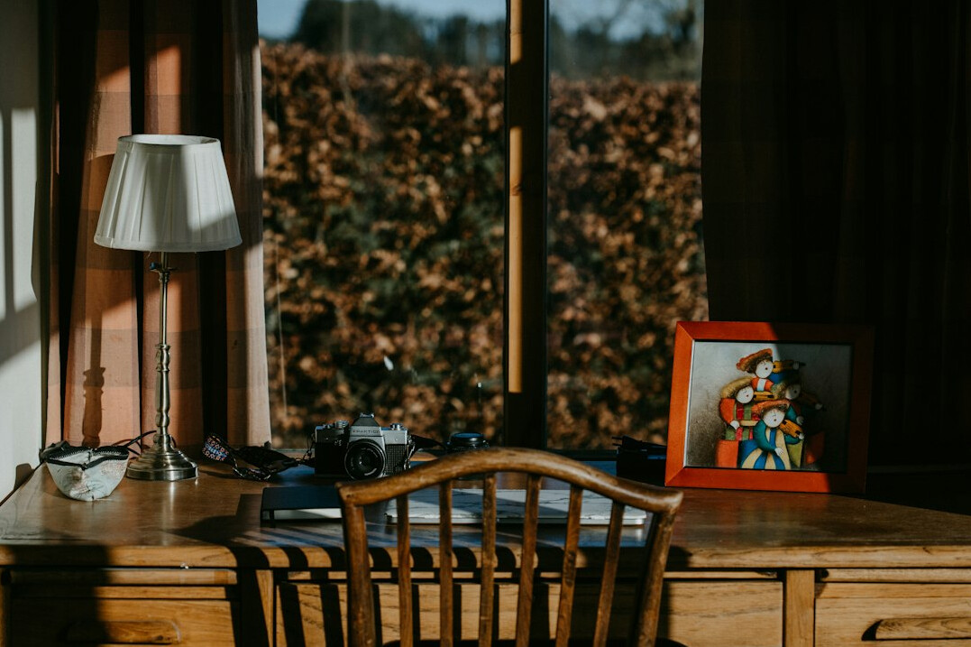 Desk with old documents, photographs and a lamp for an investigation