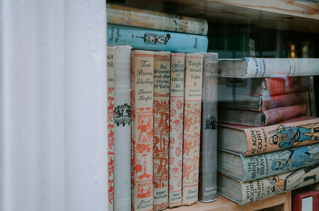 Shelves of old books and archive boxes in a historical library