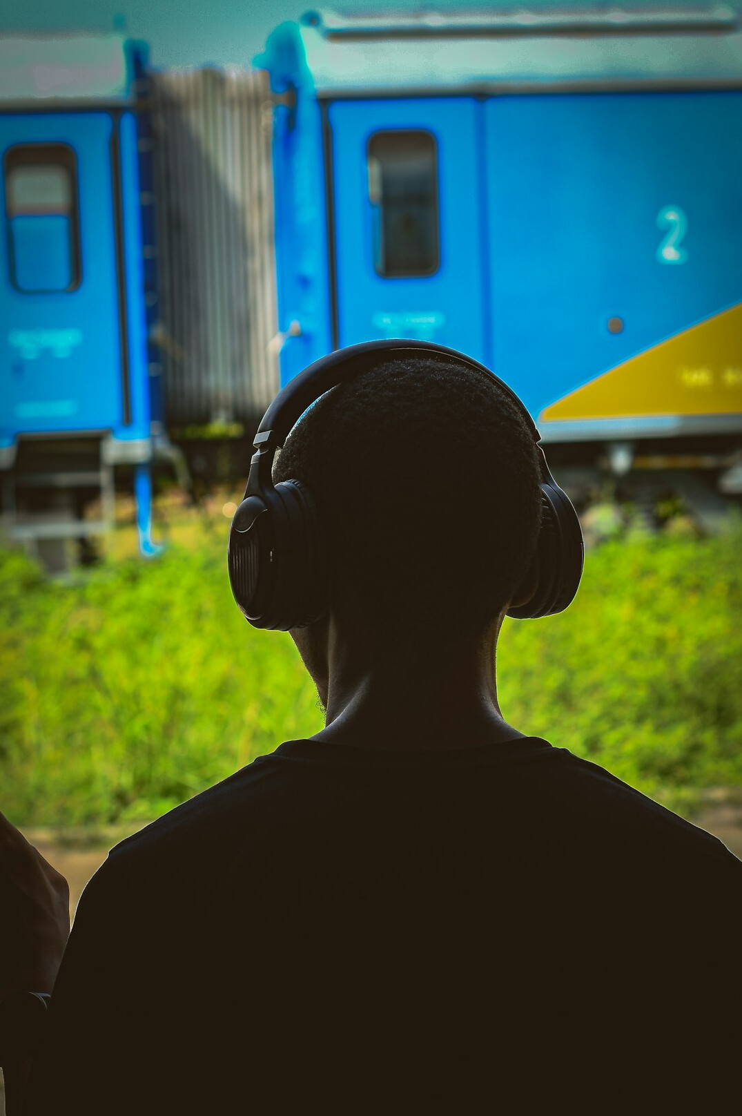 Person listening to a podcast with headphones on a train